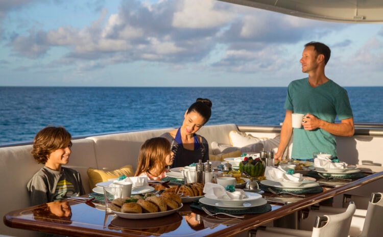 Family dining on yacht at sea